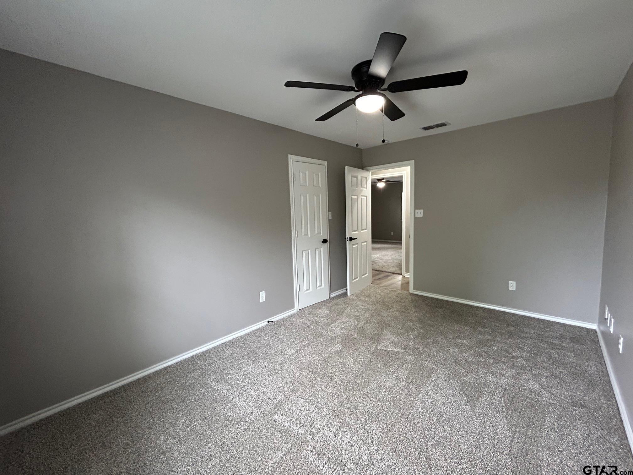 10052 Lakeshore Tyler, TX 75709 - Photo 17 of 28 a view of an empty room and a ceiling fan