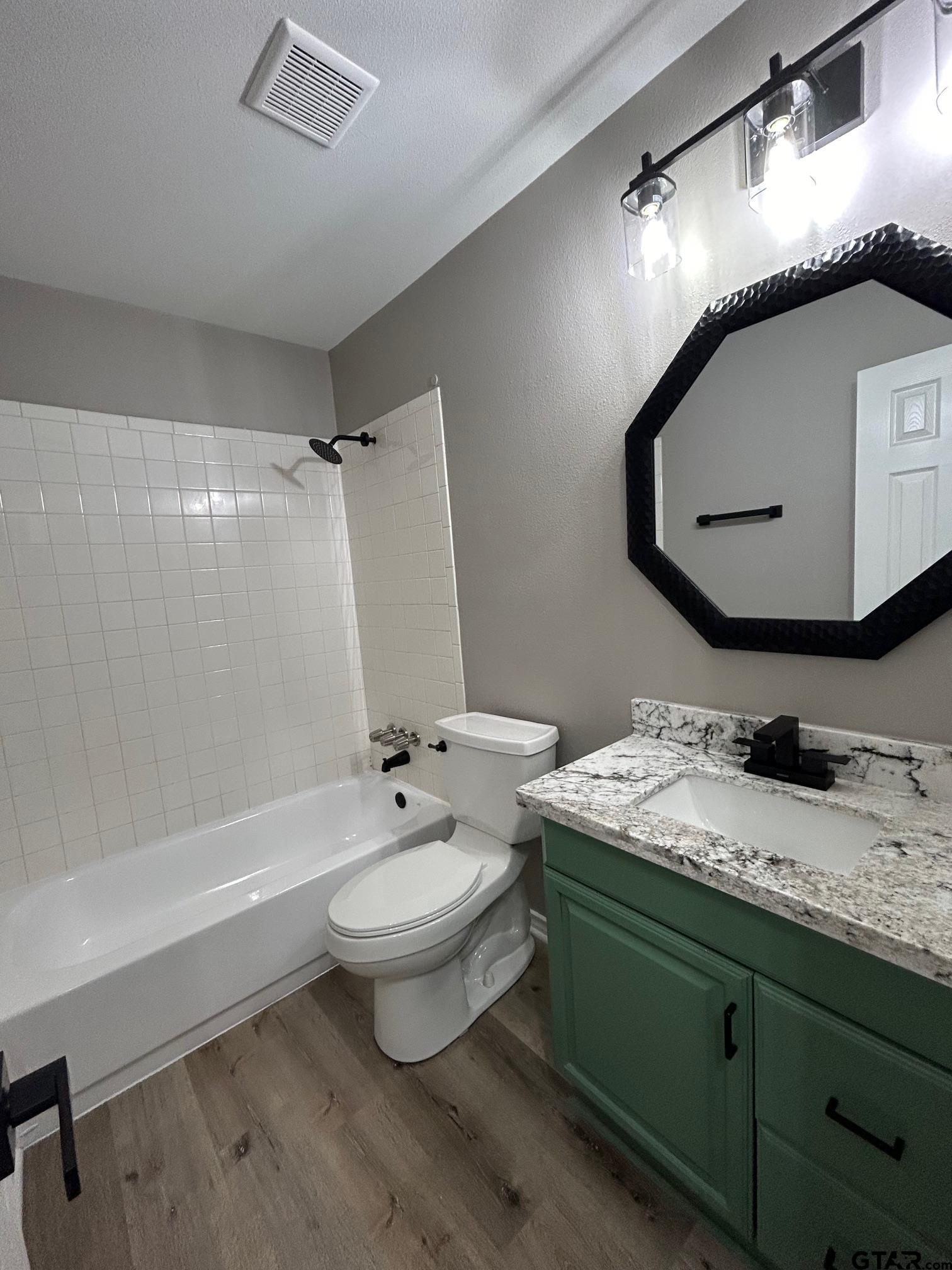 10052 Lakeshore Tyler, TX 75709 - Photo 18 of 28 a bathroom with a granite countertop sink toilet and mirror