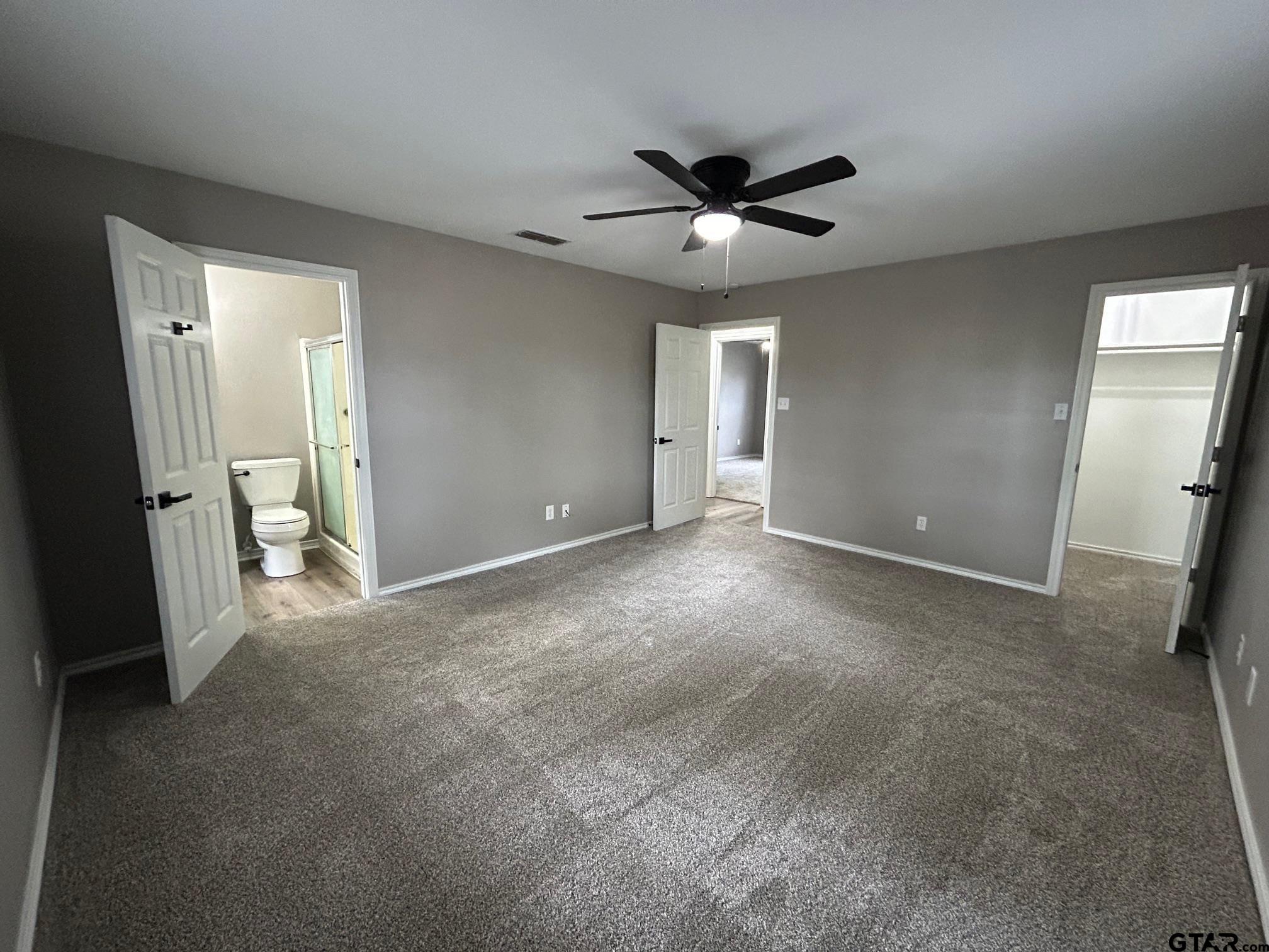 10052 Lakeshore Tyler, TX 75709 - Photo 21 of 28 an empty room with closet and a chandelier fan