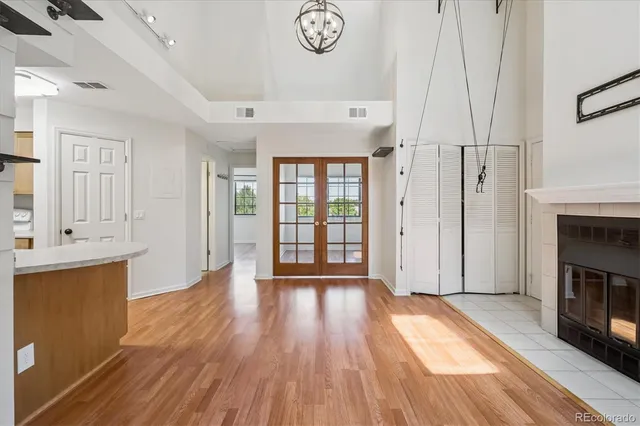 a view of a room with wooden floor and a window