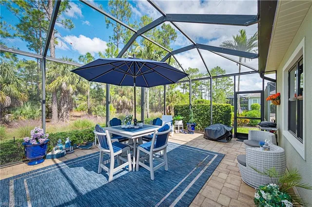 a view of a table and chairs under an umbrella in patio