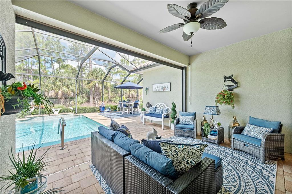 3585 Canopy Circle Naples, FL 34120 - Photo 13 of 46 a living room with furniture and a large window