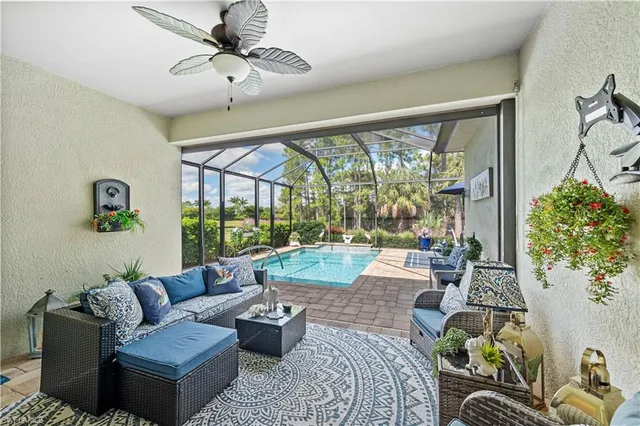a living room with patio furniture and a large window