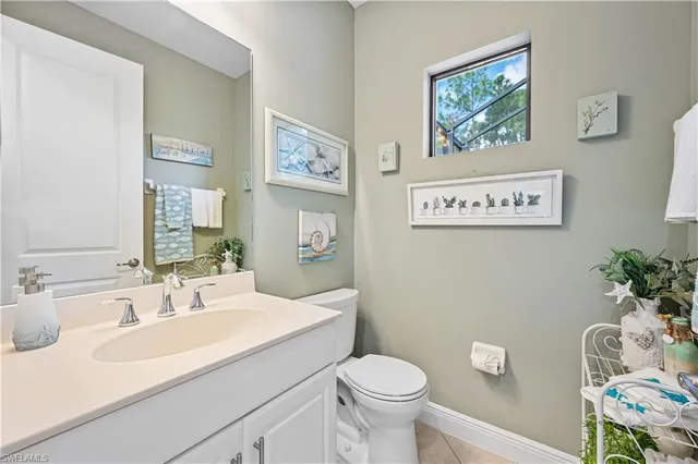 a bathroom with a sink mirror vanity and toilet