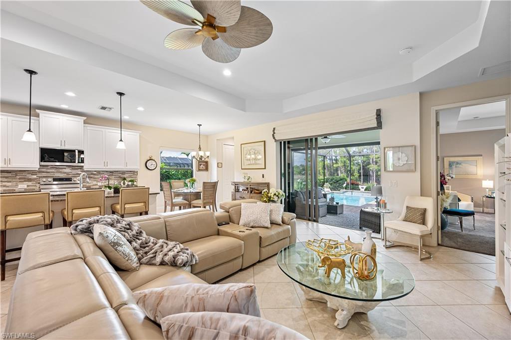 3585 Canopy Circle Naples, FL 34120 - Photo 16 of 46 a living room with furniture kitchen view and a large window