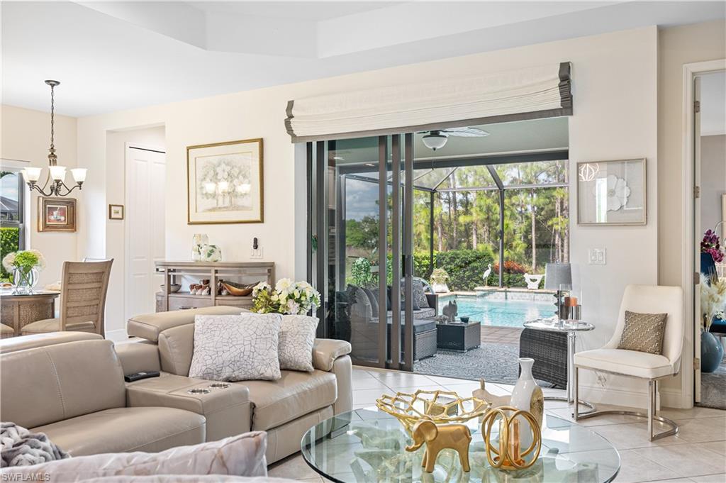 3585 Canopy Circle Naples, FL 34120 - Photo 17 of 46 a living room with furniture and a large window
