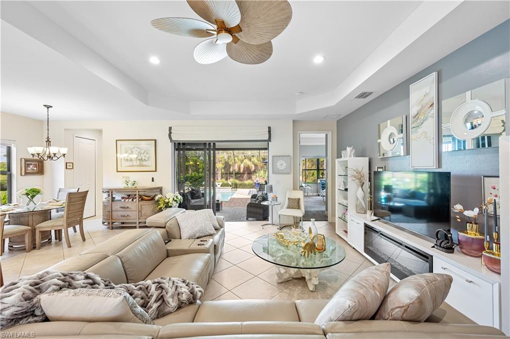 3585 Canopy Circle Naples, FL 34120 - Photo 18 of 46 a living room with furniture and a large window