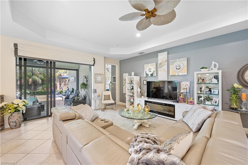 3585 Canopy Circle Naples, FL 34120 - Photo 19 of 46 a living room with furniture and a flat screen tv