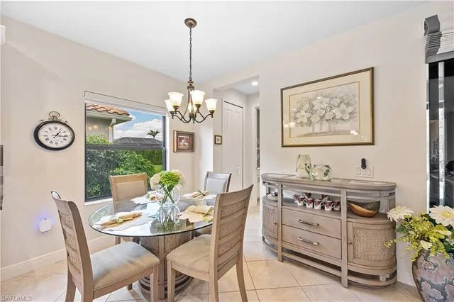 a view of a dining room with furniture a chandelier and wooden floor