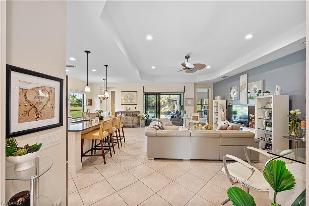 3585 Canopy Circle Naples, FL 34120 - Photo 30 of 46 a living room with fireplace furniture and a painting on the wall
