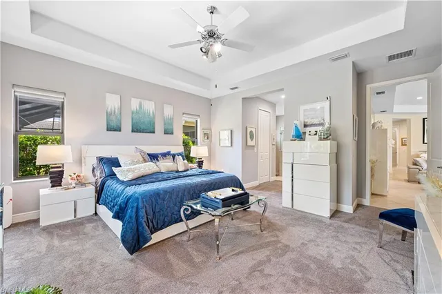 a spacious bedroom with a bed a couch and dresser