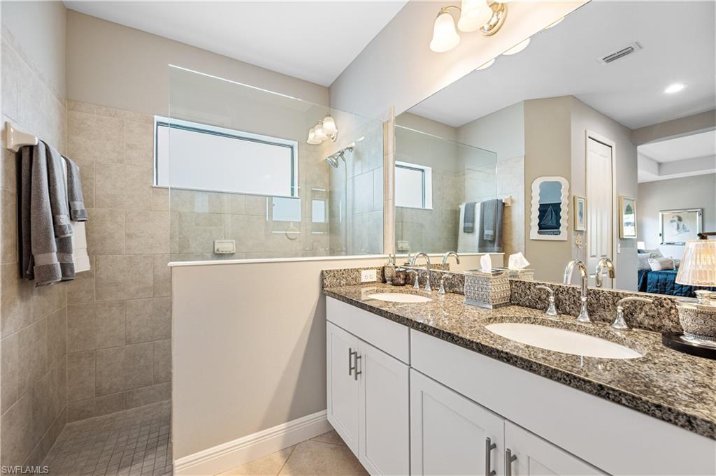 3585 Canopy Circle Naples, FL 34120 - Photo 38 of 46 a bathroom with a granite countertop sink and a mirror