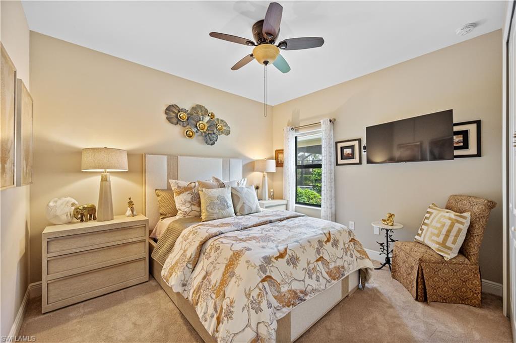 3585 Canopy Circle Naples, FL 34120 - Photo 39 of 46 a bedroom with a bed and a chandelier