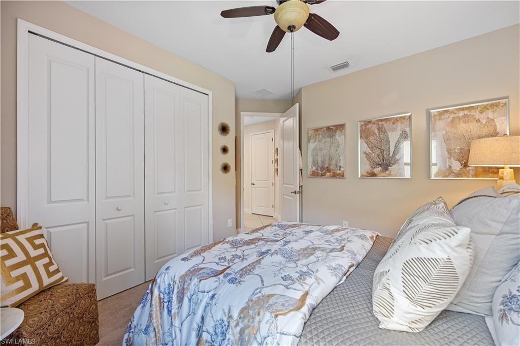 3585 Canopy Circle Naples, FL 34120 - Photo 40 of 46 a bedroom with a bed and a chandelier