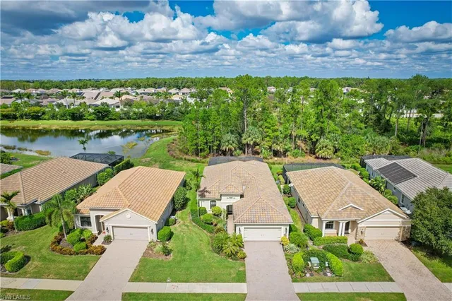 an aerial view of a house with a garden and lake view