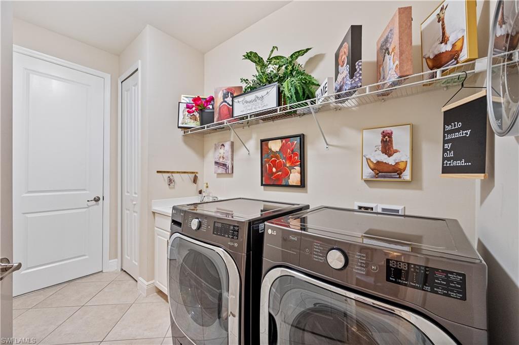 3585 Canopy Circle Naples, FL 34120 - Photo 45 of 46 a utility room with dryer washer and a mirror