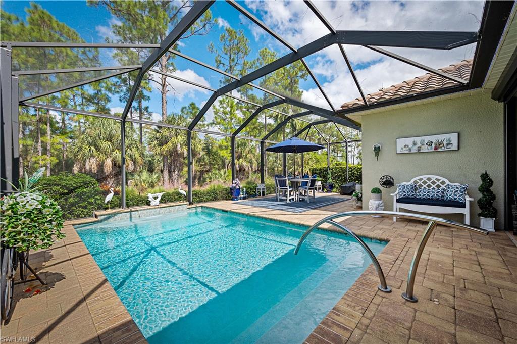 3585 Canopy Circle Naples, FL 34120 - Photo 10 of 46 a view of a swimming pool with a patio