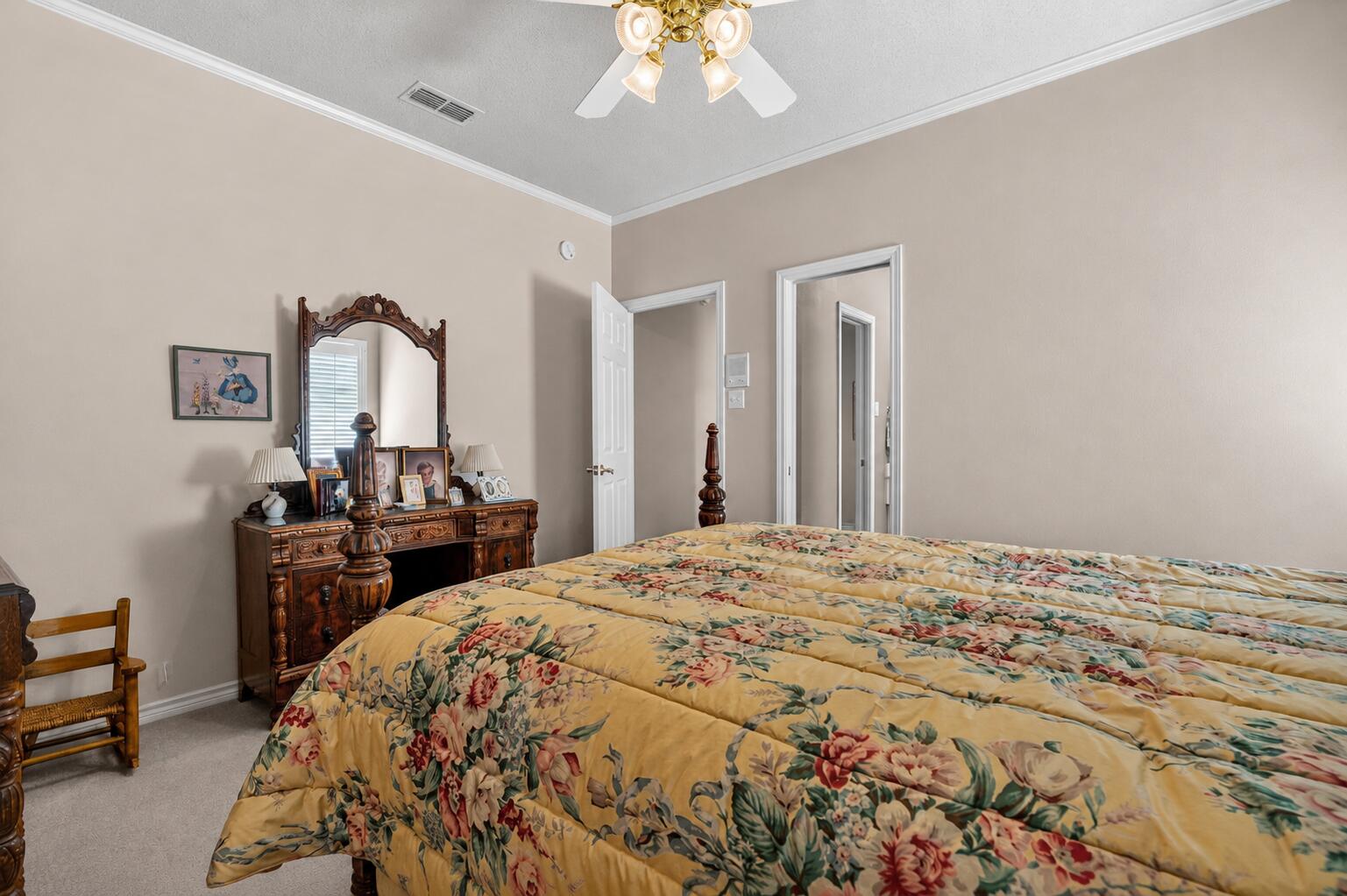 7402 95th Street Lubbock, TX 79424 - Photo 34 of 43 a bedroom with a bed and a chandelier