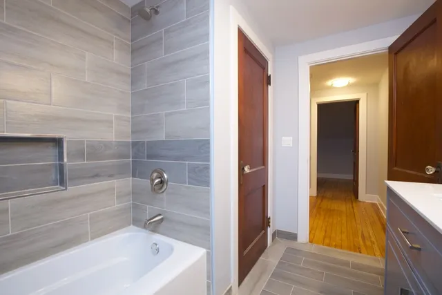 a bathroom with a tub and shower