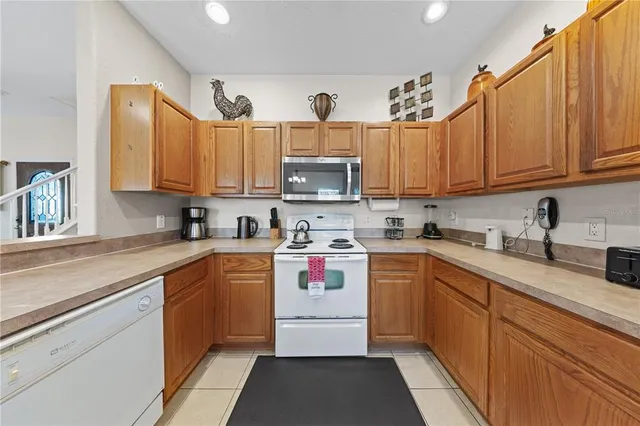 a bedroom with a bed and dresser with wooden floor