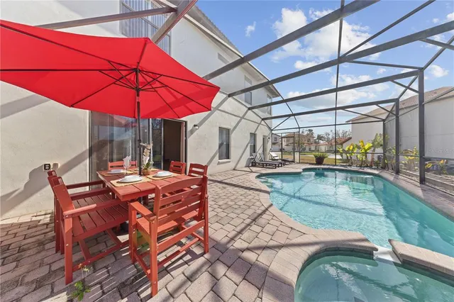 a room with pool table and glass windows