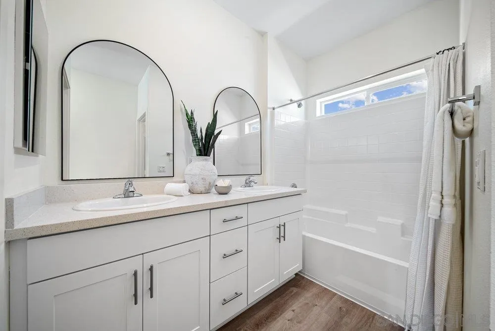 8186 Golden Avenue Lemon Grove, CA 91945 - Photo 22 of 50 a bathroom with a double vanity sink and mirror with bathtub