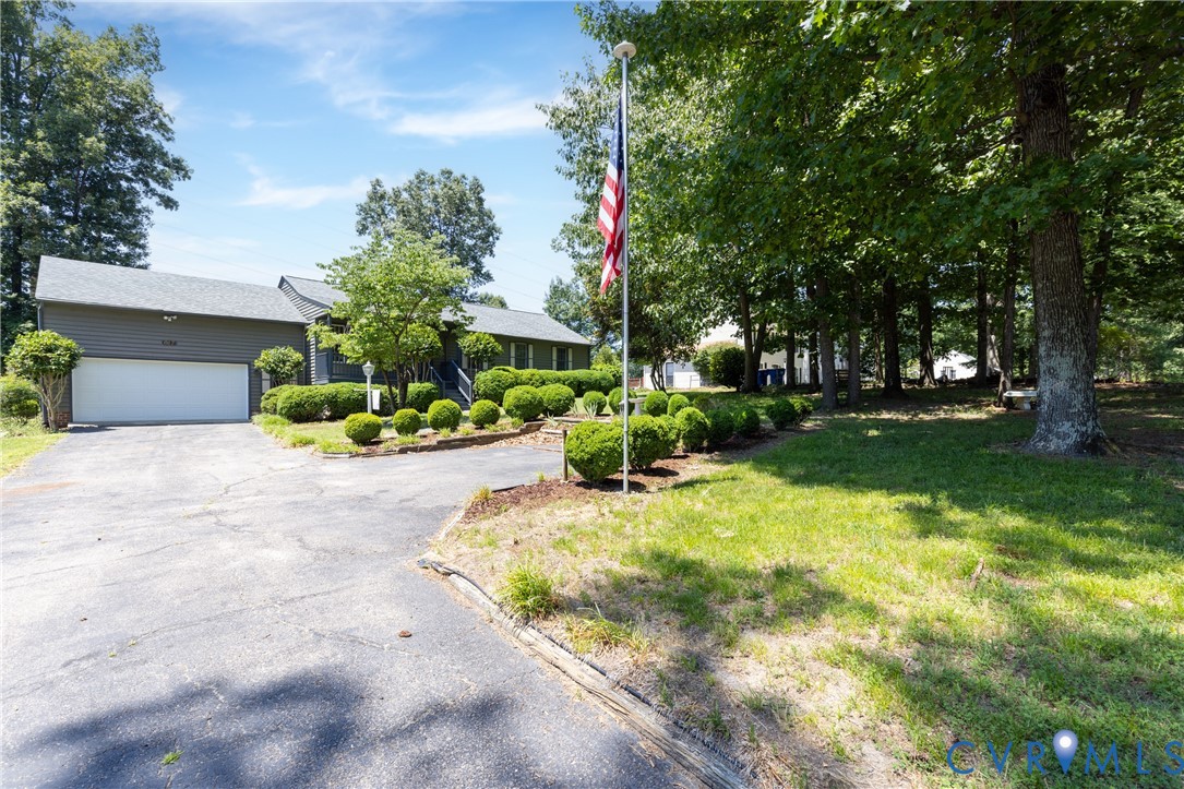 617 Rebel Ridge Road Colonial Heights, VA 23834 - Photo 2 of 49 a front view of a house with a yard garage and outdoor seating