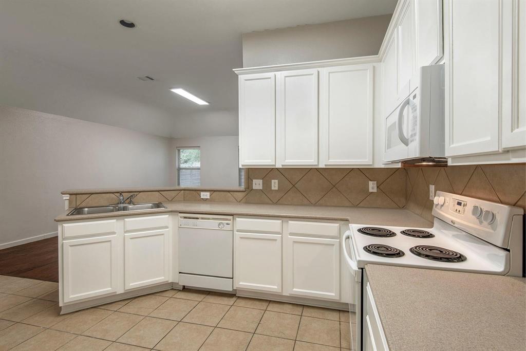 448 Northbrook Avenue Oak Point, TX 75068 - Photo 4 of 12 a kitchen with a sink a stove and cabinets