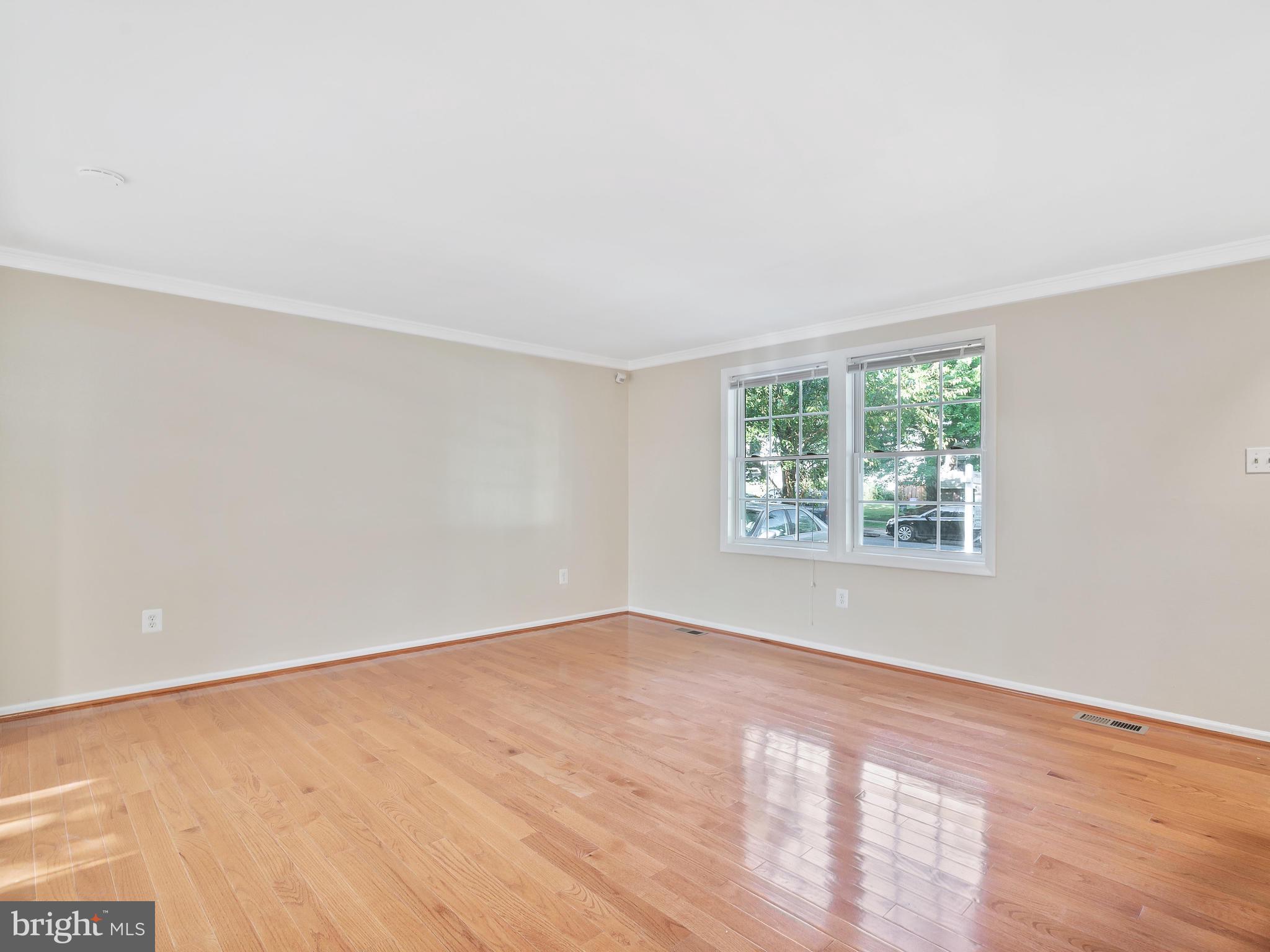 19044 Staleybridge Road Germantown, MD 20876 - Photo 6 of 30 an empty room with wooden floor and windows