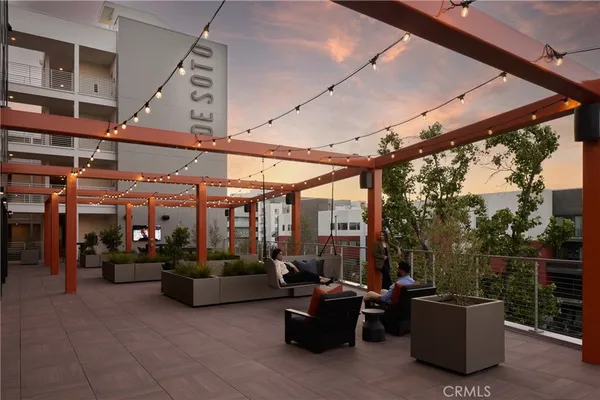 a room with lots of tables a large mirror and furniture