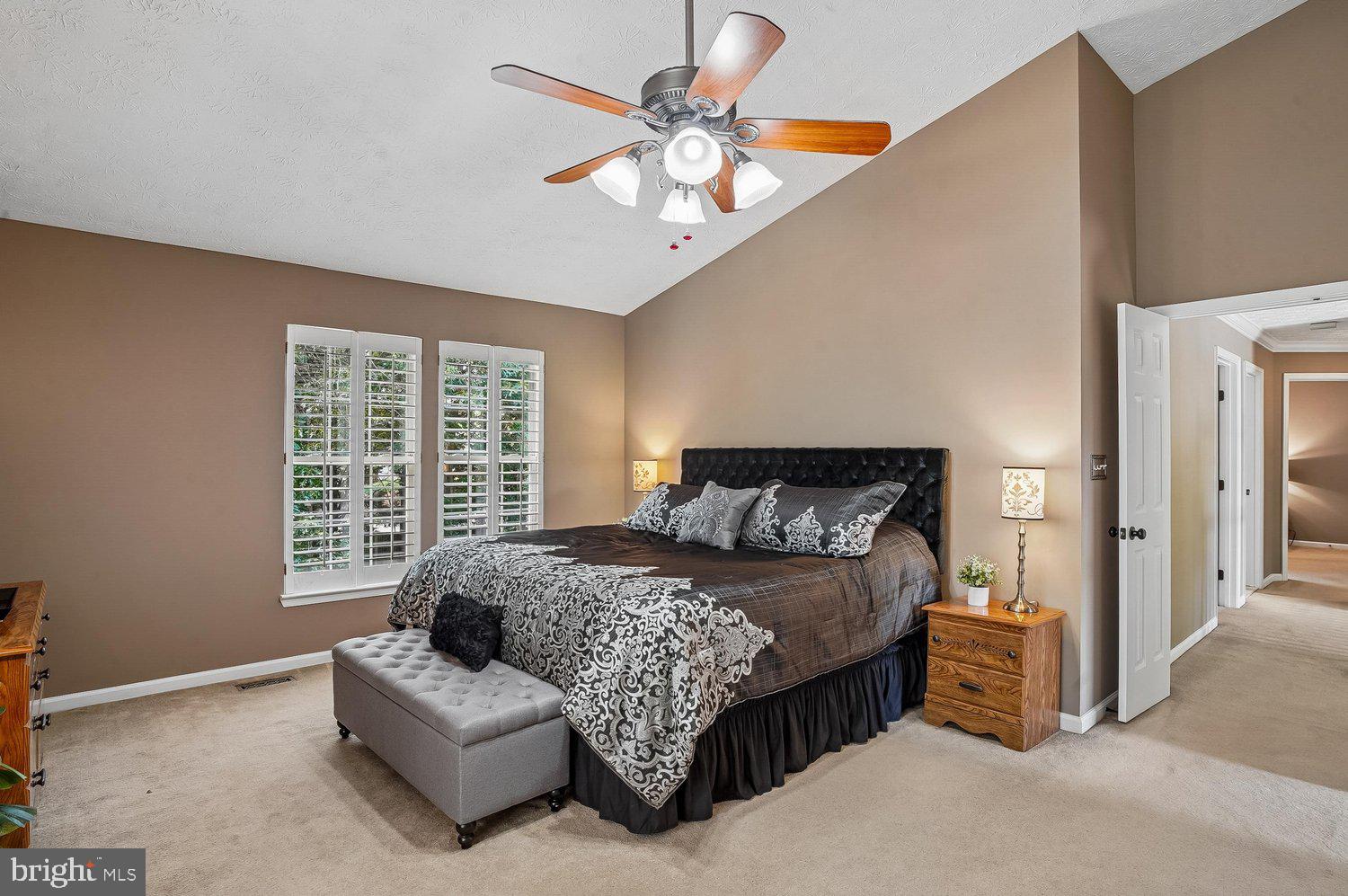 217 Raccoon Run Court Hanover, MD 21076 - Photo 17 of 38 a bedroom with a bed a chandelier and a couch