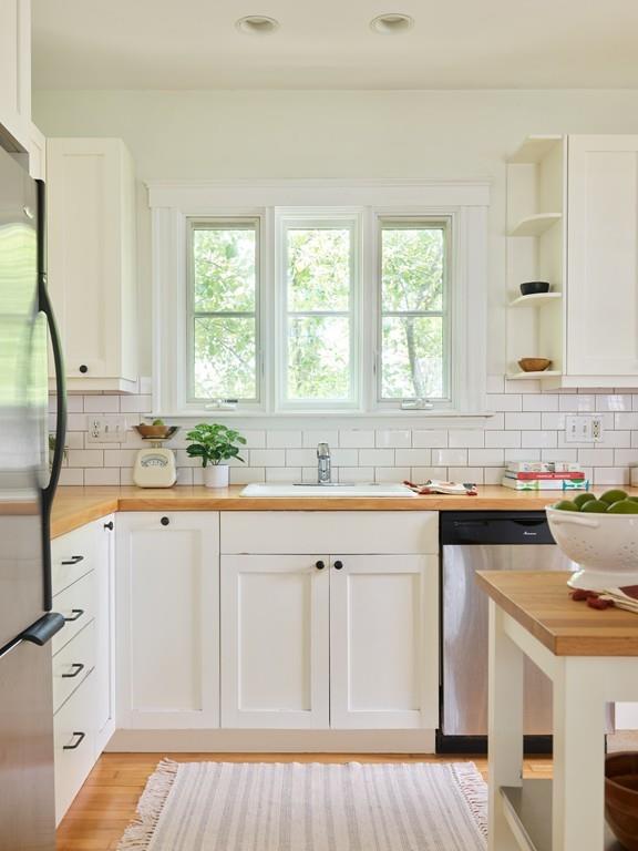 18 Bonad Road Arlington, MA 02476 - Photo 8 of 23 a kitchen with white cabinets and a window