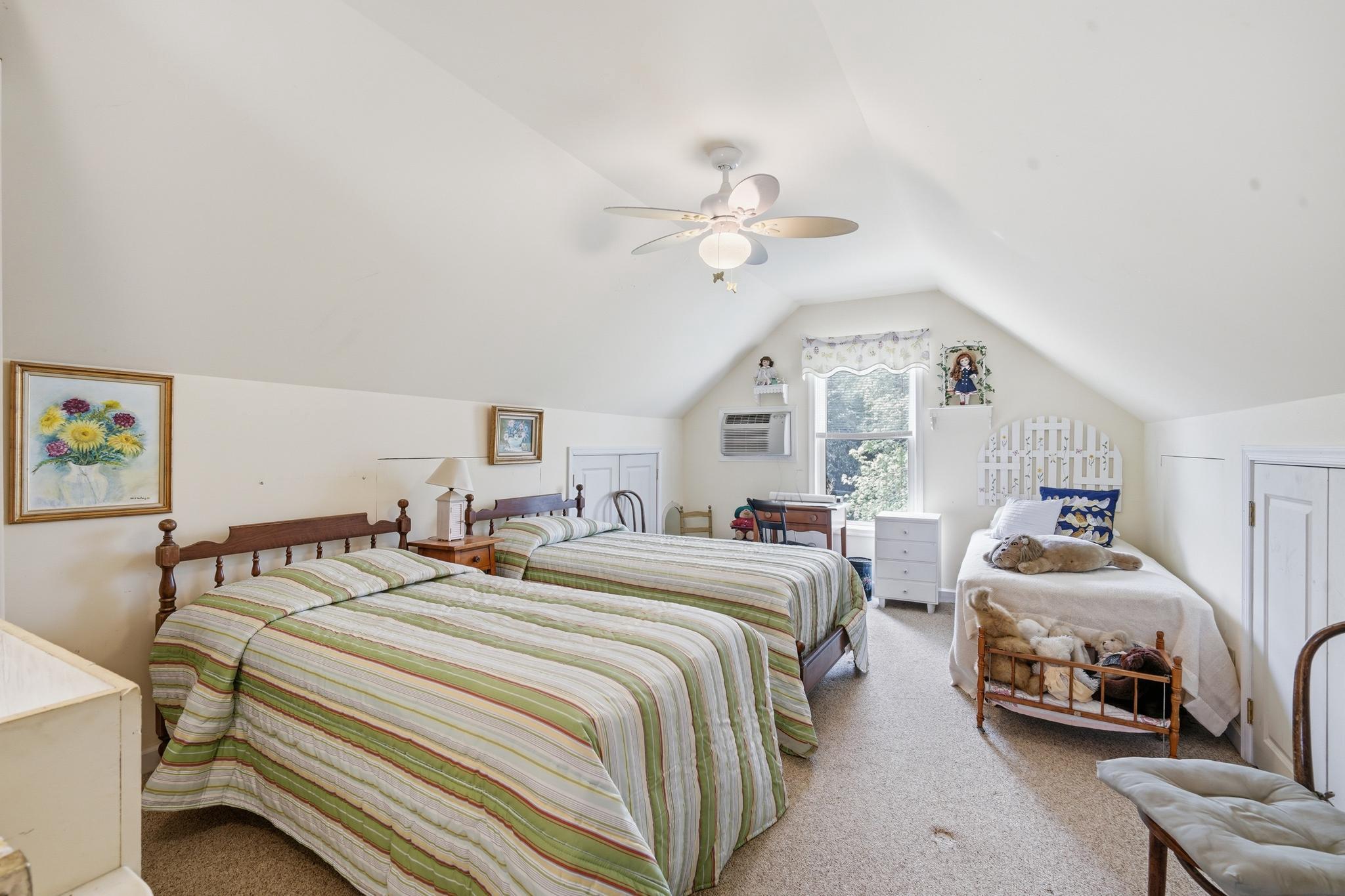 14136 Kentmore Park Road Kennedyville, MD 21645 - Photo 33 of 54 a spacious bedroom with two beds and a chandelier