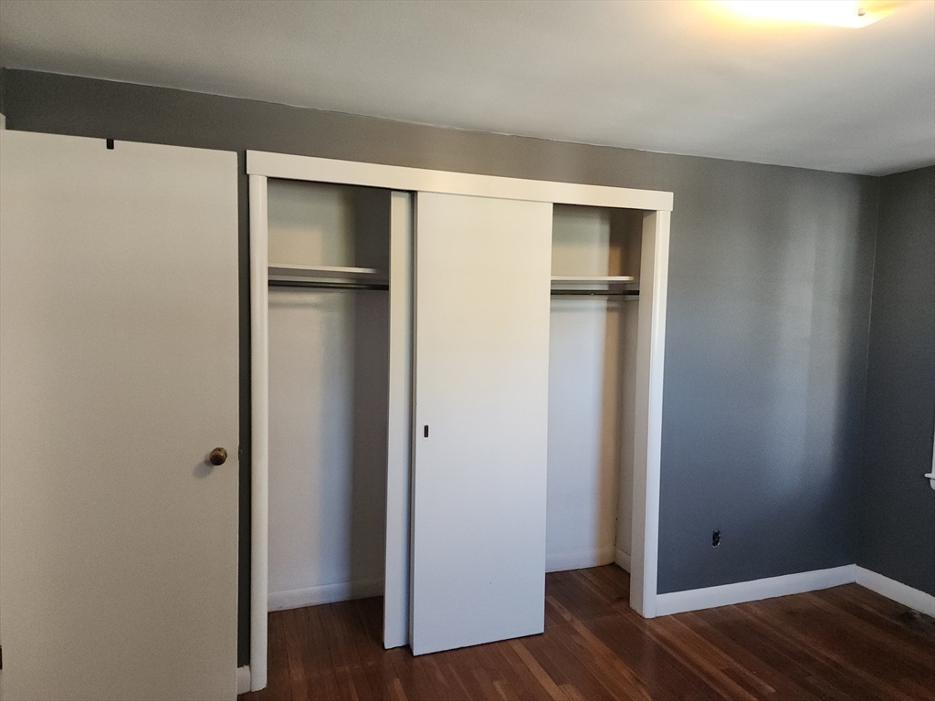 23 Brewster Road Weymouth, MA 02191 - Photo 13 of 21 a view of an empty room with wooden floor and closet