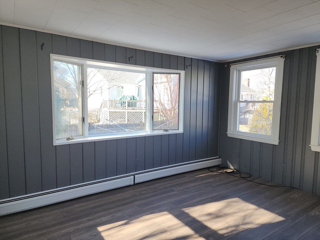 23 Brewster Road Weymouth, MA 02191 - Photo 16 of 21 a view of an empty room with wooden floor and a window