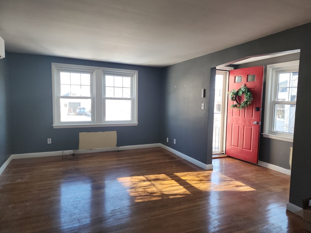 23 Brewster Road Weymouth, MA 02191 - Photo 5 of 21 a view of empty room with wooden floor and fan