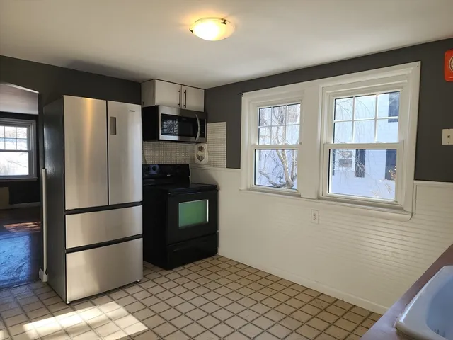 a kitchen with stainless steel appliances a refrigerator and a stove top oven