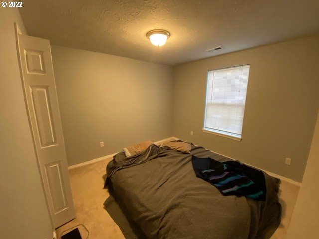 37227 Solso Road Sandy, OR 97055 - Photo 22 of 28 a bedroom with a bed and a window