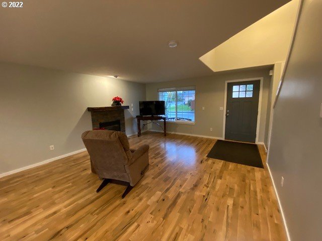 37227 Solso Road Sandy, OR 97055 - Photo 9 of 28 a living room with couches chairs and a coffee table with wooden floor