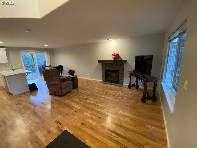 37227 Solso Road Sandy, OR 97055 - Photo 10 of 28 a living room with furniture a flat screen tv and a fireplace