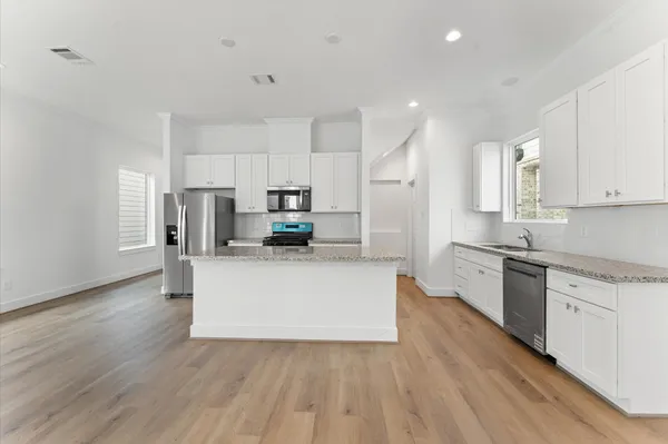 a kitchen with stainless steel appliances a refrigerator sink and cabinets