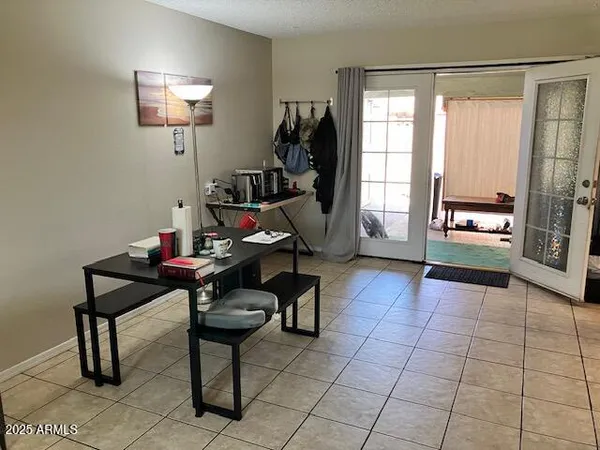 a living room with furniture a dining table and a window