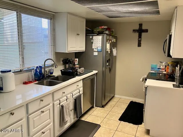 a kitchen with stainless steel appliances a sink and a refrigerator