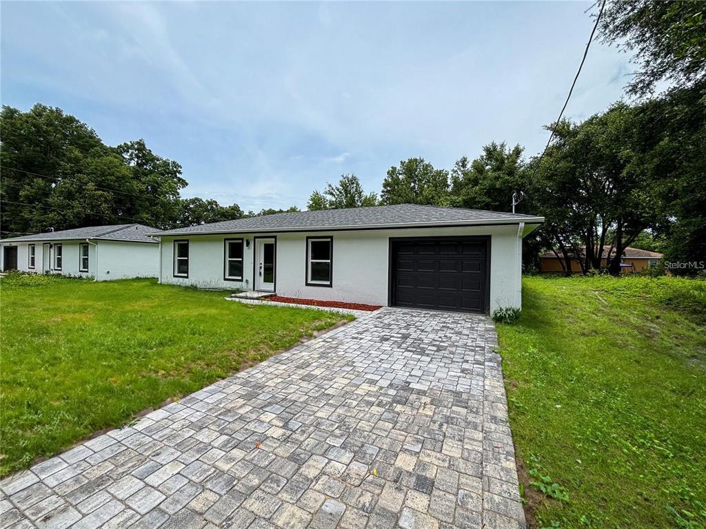 4202 Westminster Road Sebring, FL 33875 - Photo 1 of 8 a front view of house with yard and green space
