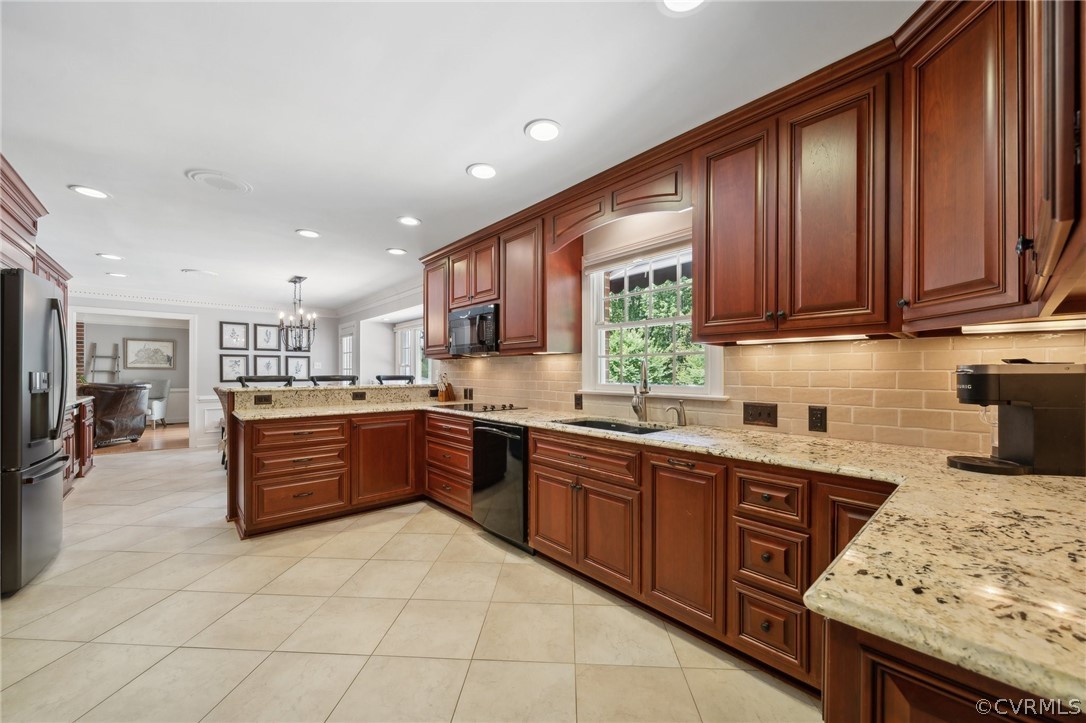 5550 Quail Ridge Terrace Chesterfield, VA 23832 - Photo 8 of 44 a kitchen with stainless steel appliances granite countertop wooden cabinets a stove top oven a sink and dishwasher