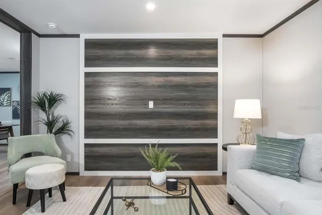a living room with furniture and a potted plant
