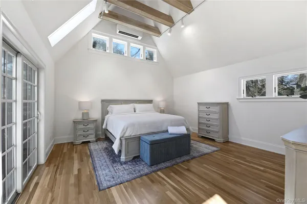 a bedroom with a bed and a view of kitchen