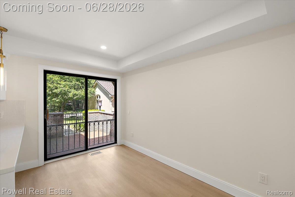 1447 Ravineview Court, Unit C12 Bloomfield Hills, MI 48304 - Photo 21 of 49 Sliding glass door opening to a private balcony with black wrought iron railing