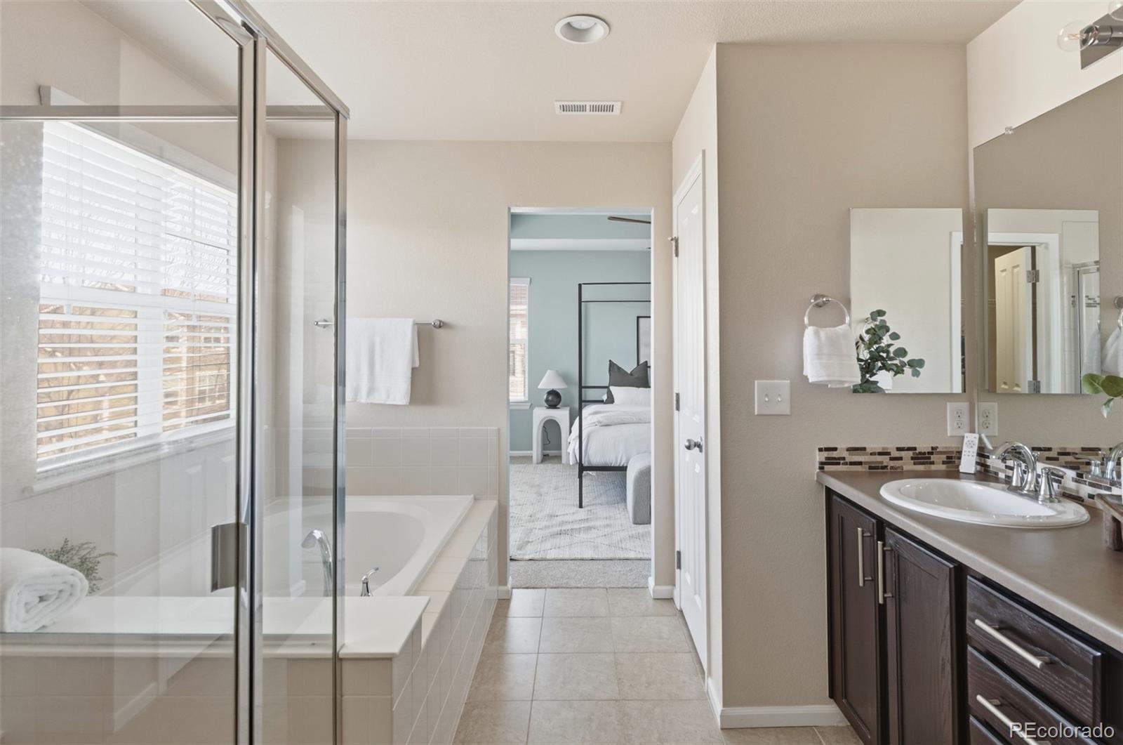 1150 Mircos Street Erie, CO 80516 - Photo 21 of 46 a bathroom with a tub sink and mirror