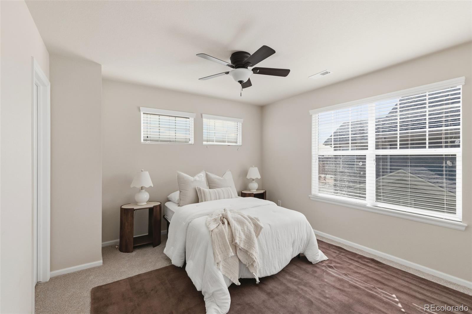 1150 Mircos Street Erie, CO 80516 - Photo 25 of 46 a bedroom with a bed and a large window
